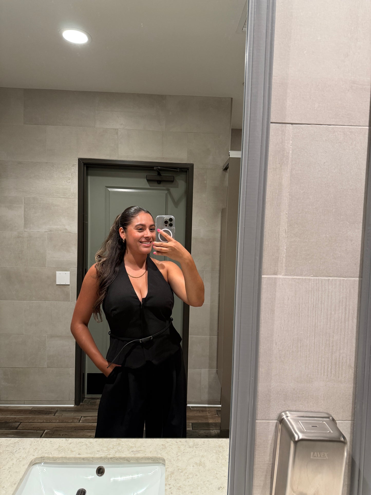 Black two piece set with halter top includes a black belt and zipper nd buttoned pants with pockets